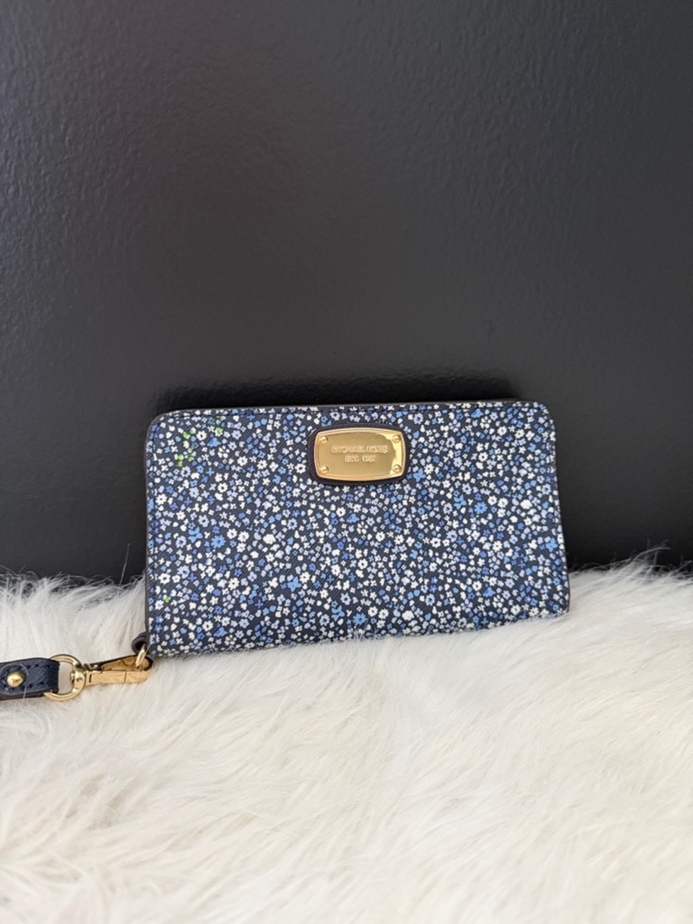 Michael Kors Slim Tech wristlet features a distinct blue floral pattern